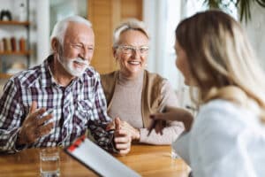 Couple smiling and speaking with a nurse.